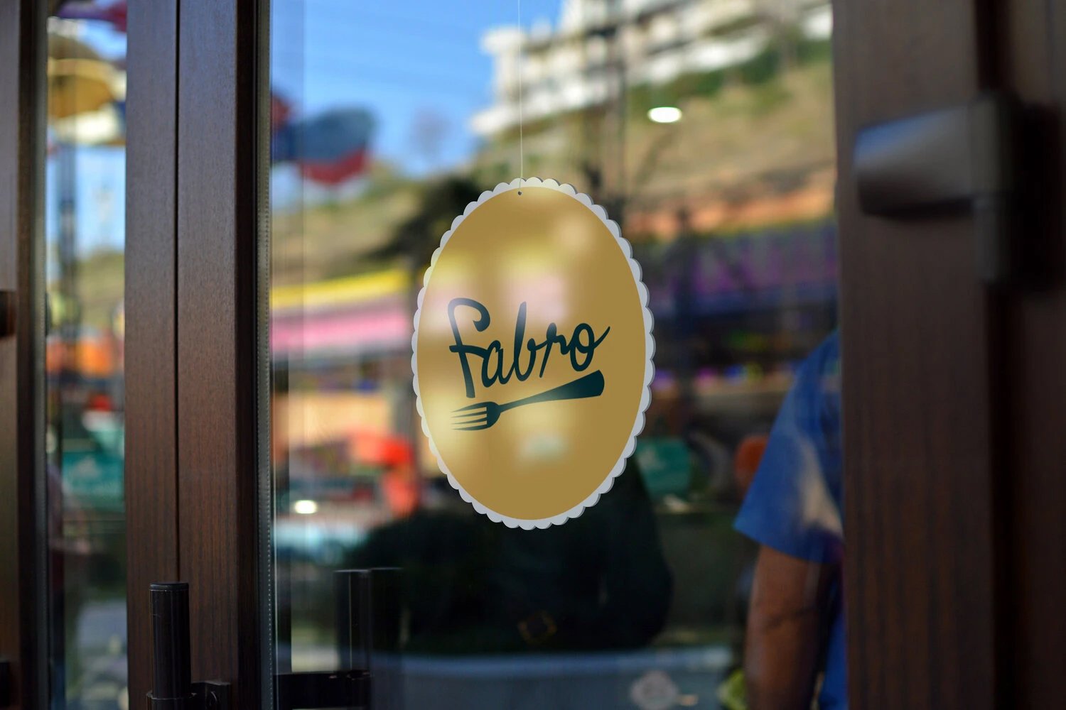Round gold Fabro sticker on a restaurant glass door